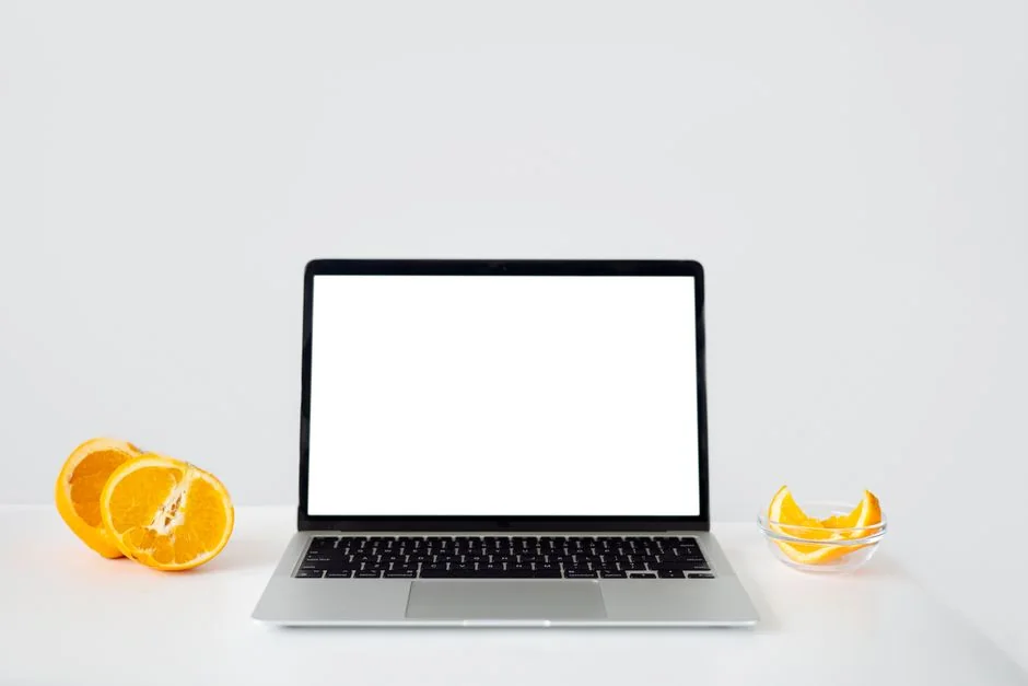 A contemporary workspace showcasing a laptop, tablet, and smartphones, ideal for tech and freelance use.